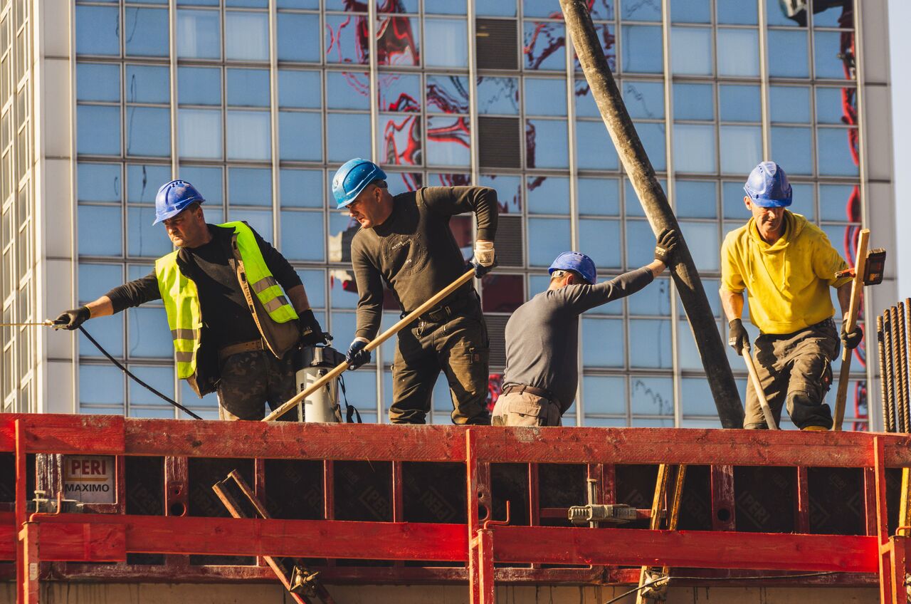 Construction crew in safety gear working on a building